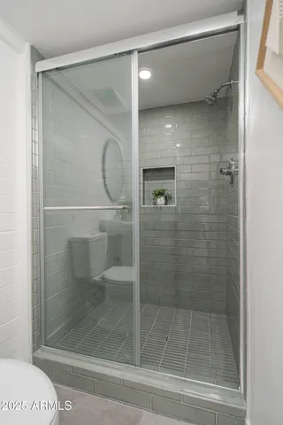 a bathroom with a glass shower door