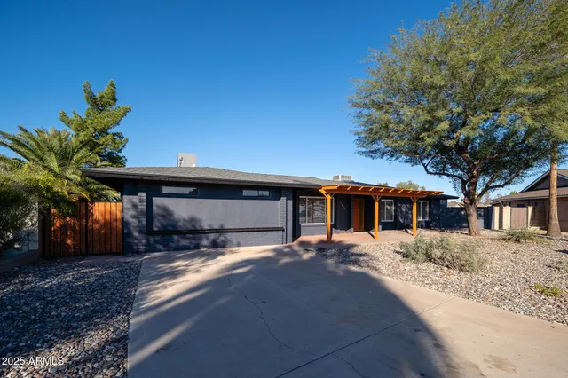 a view of a house with a yard and tree s