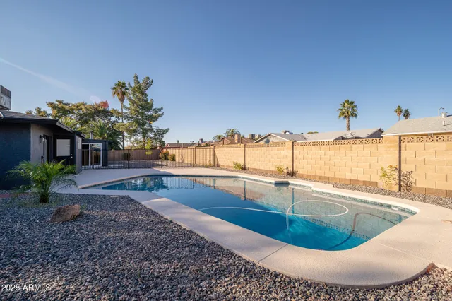 a view of a swimming pool with a lounge chairs