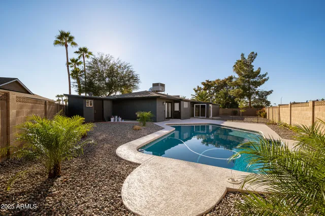 a view of a backyard with plants and a patio