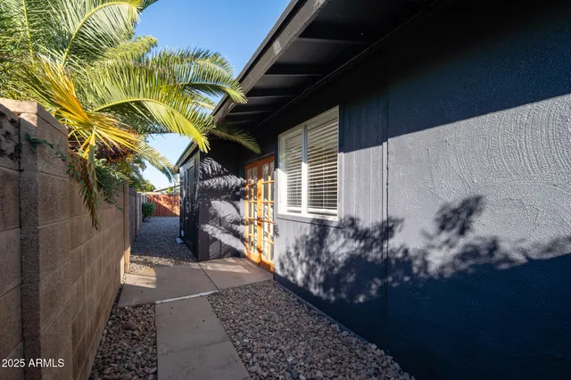 a view of a pathway of a house with a yard