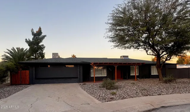 a view of a house with a tree and a yard