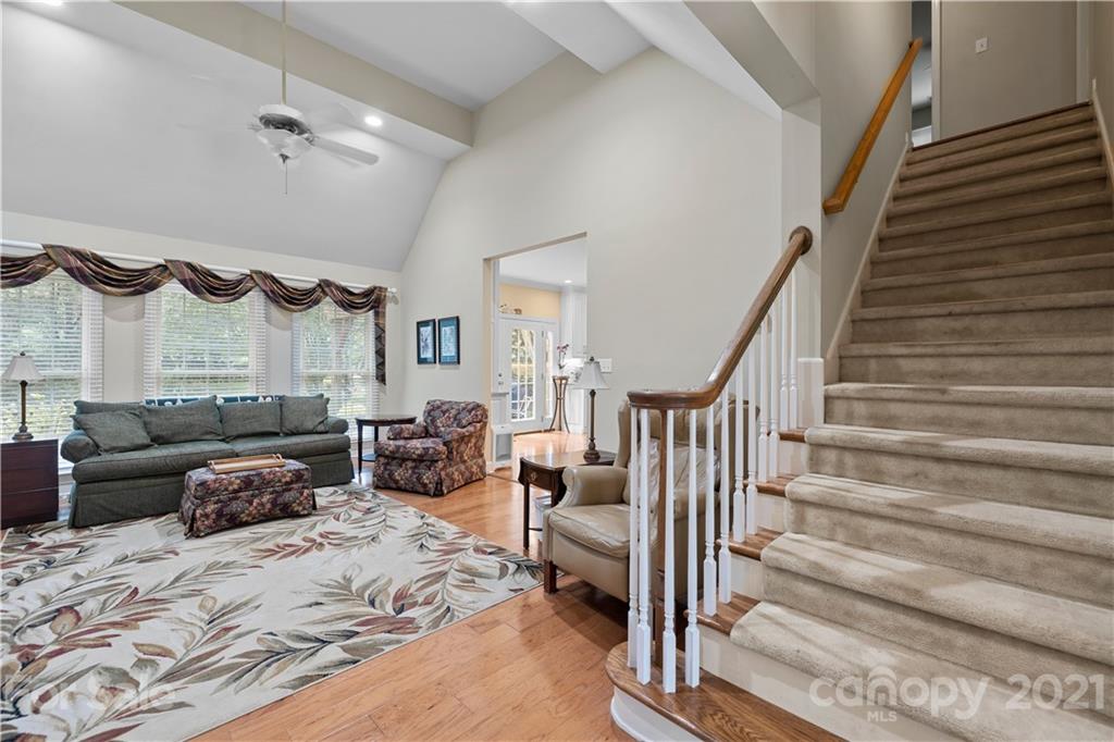 348 Gringley Hill Road Fort Mill, SC 29708 - Photo 13 of 33 a bedroom with furniture and a chandelier