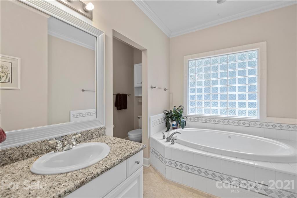348 Gringley Hill Road Fort Mill, SC 29708 - Photo 19 of 33 a bathroom with a granite countertop tub sink and mirror