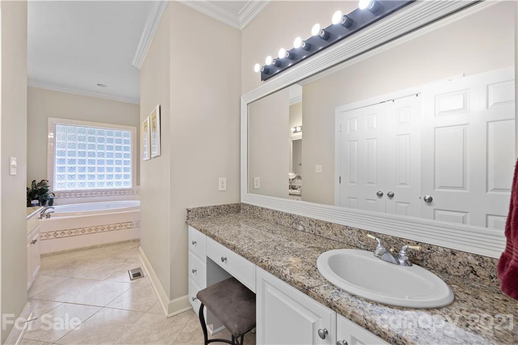 348 Gringley Hill Road Fort Mill, SC 29708 - Photo 21 of 33 a bathroom with a granite countertop sink and a mirror