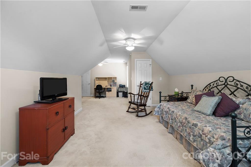 348 Gringley Hill Road Fort Mill, SC 29708 - Photo 27 of 33 a bedroom with furniture and a flat screen tv