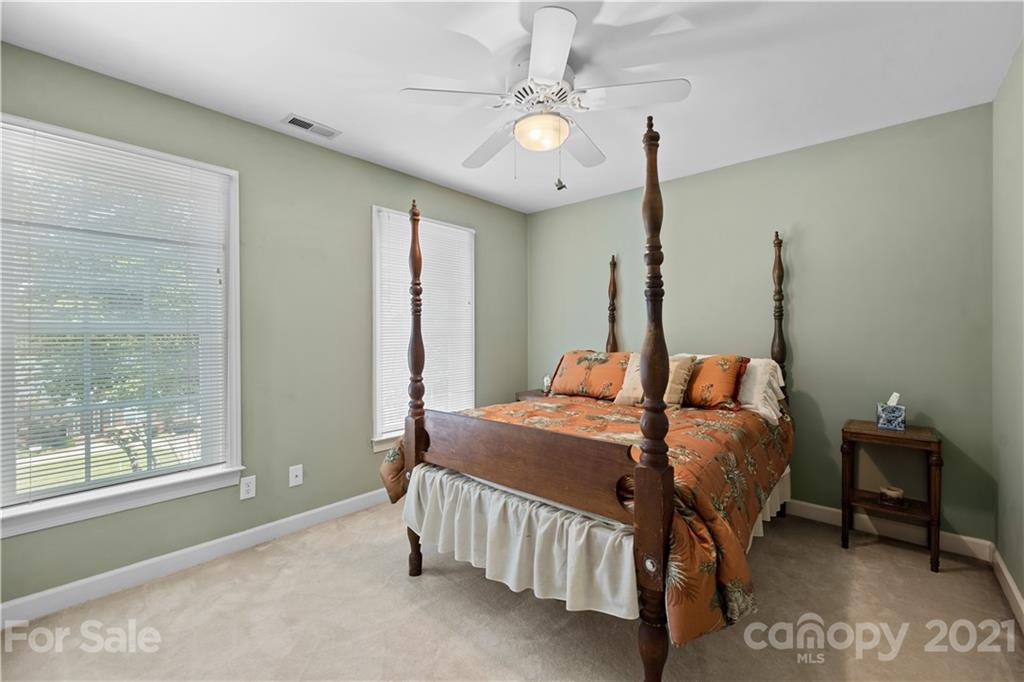 348 Gringley Hill Road Fort Mill, SC 29708 - Photo 29 of 33 a bedroom with a bed and a chandelier