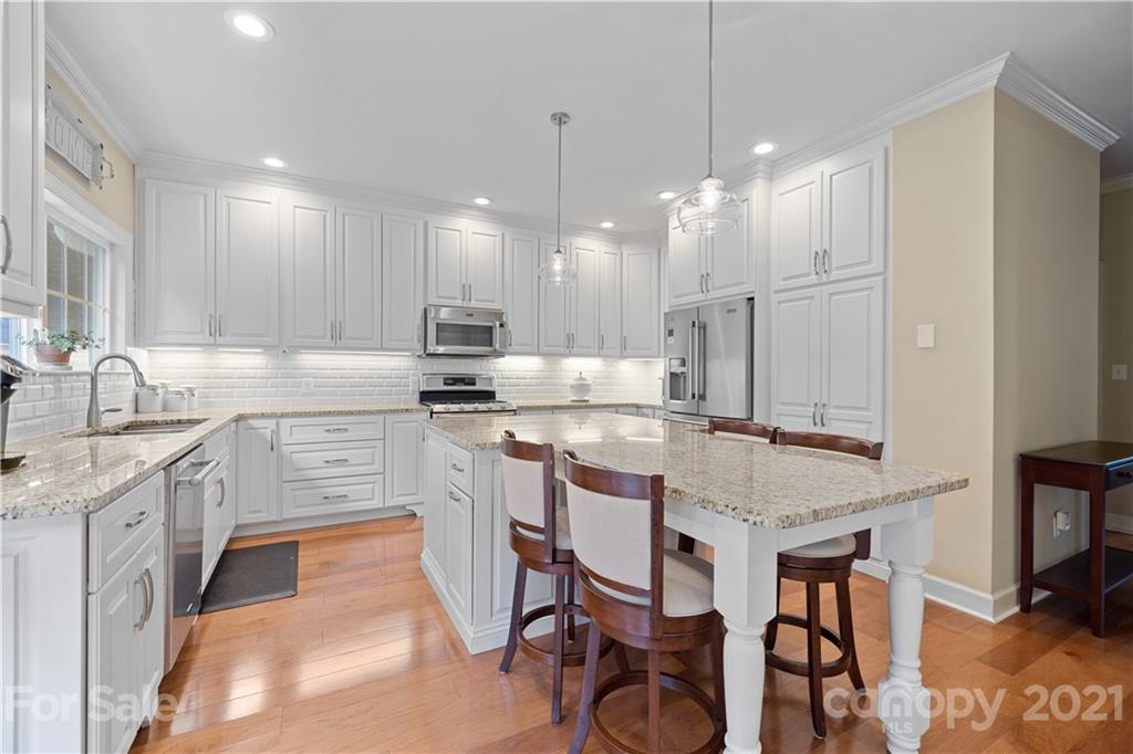 348 Gringley Hill Road Fort Mill, SC 29708 - Photo 4 of 33 a kitchen with granite countertop a sink appliances cabinets and furniture