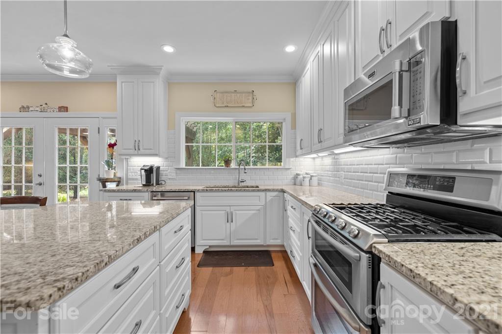 348 Gringley Hill Road Fort Mill, SC 29708 - Photo 5 of 33 a kitchen with stainless steel appliances granite countertop a stove and a sink