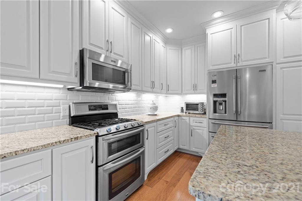 348 Gringley Hill Road Fort Mill, SC 29708 - Photo 6 of 33 a kitchen with granite countertop cabinets stainless steel appliances and a counter space