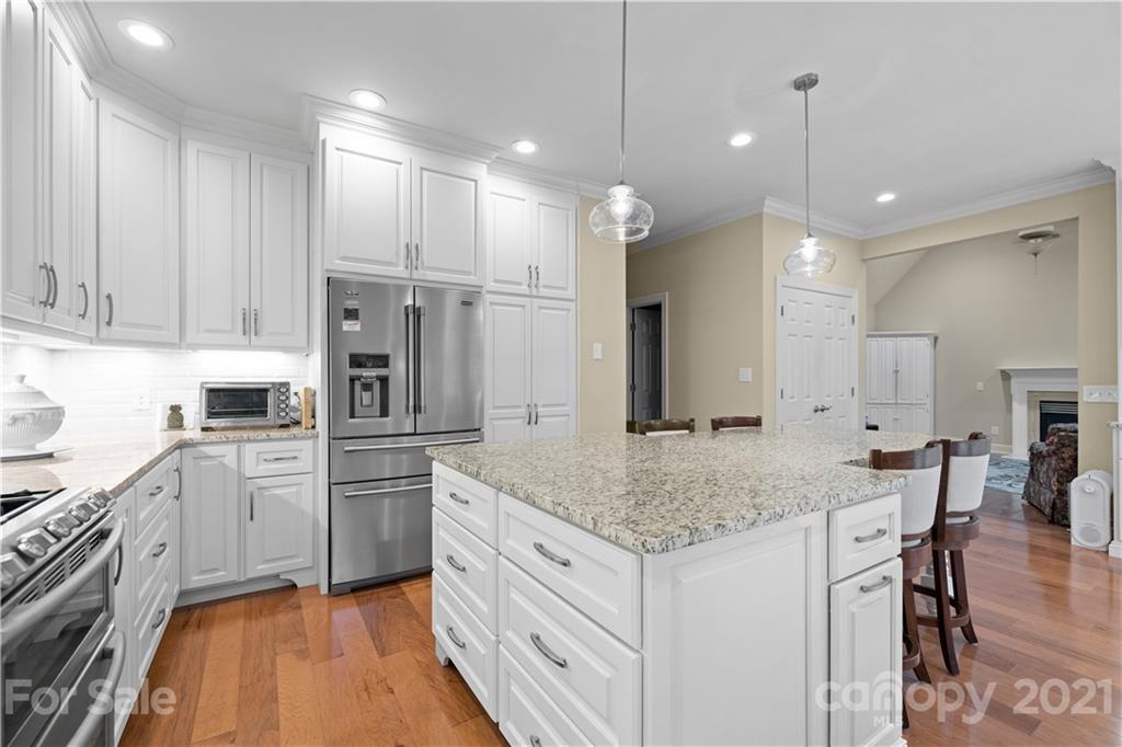 348 Gringley Hill Road Fort Mill, SC 29708 - Photo 7 of 33 a kitchen with white cabinets and stainless steel appliances