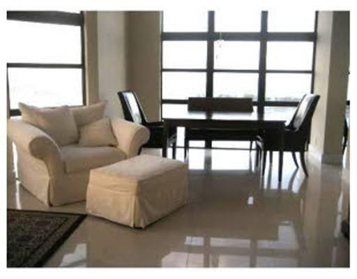 1925 Brickell Avenue, Unit DPH5 Miami, FL 33129 - Photo 2 of 4 a living room with furniture and a floor to ceiling window