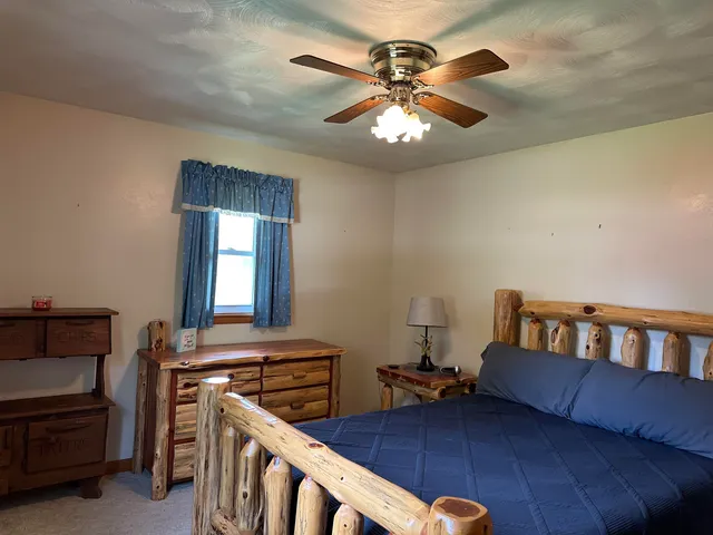 a bedroom with furniture and a chandelier