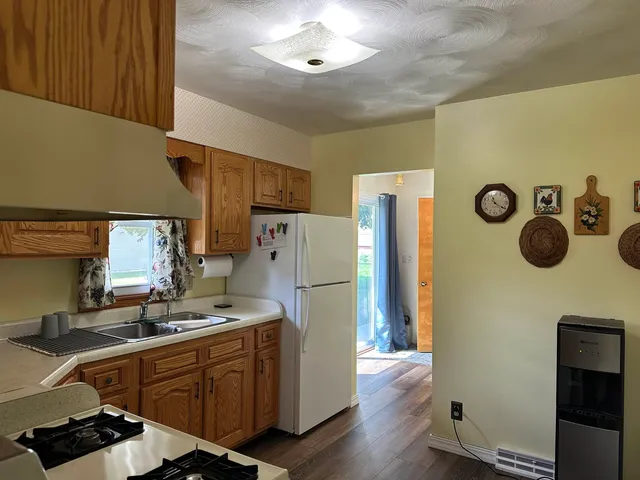 a kitchen with a refrigerator and a stove top oven