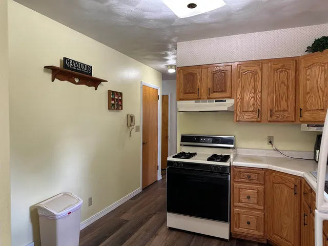 a kitchen with stainless steel appliances a stove a refrigerator and cabinets