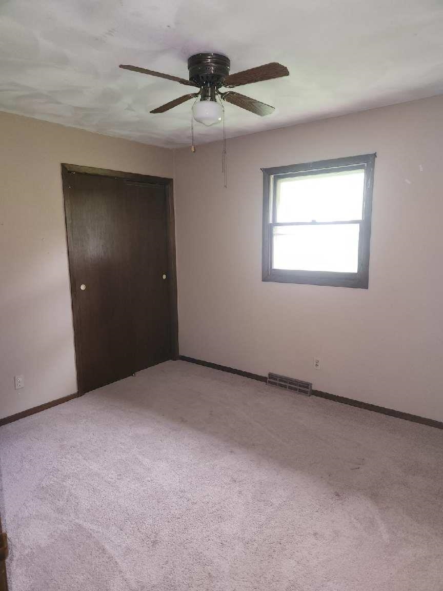 1281 Spring Center Road Belvidere, IL 61008 - Photo 12 of 19 an empty room with a ceiling fan and window