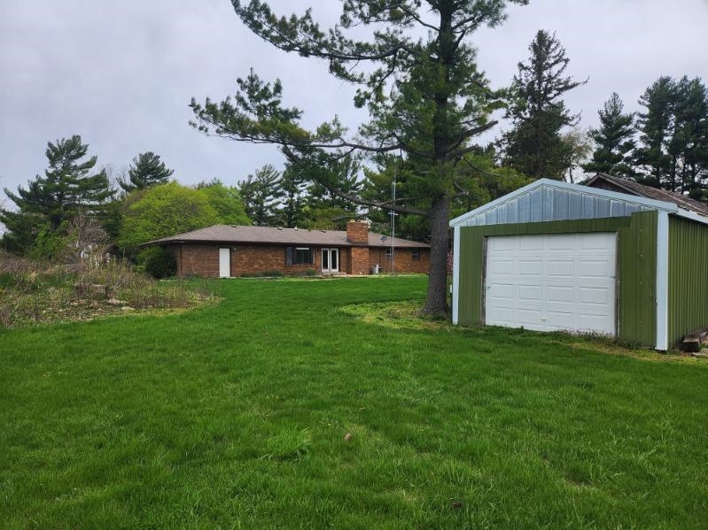 1281 Spring Center Road Belvidere, IL 61008 - Photo 3 of 19 a front view of a house with a garden and yard