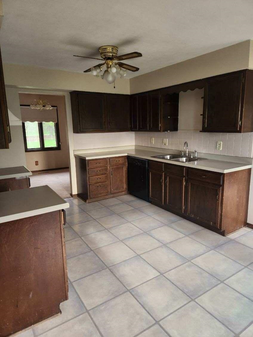 1281 Spring Center Road Belvidere, IL 61008 - Photo 10 of 19 a kitchen with stainless steel appliances a sink and cabinets