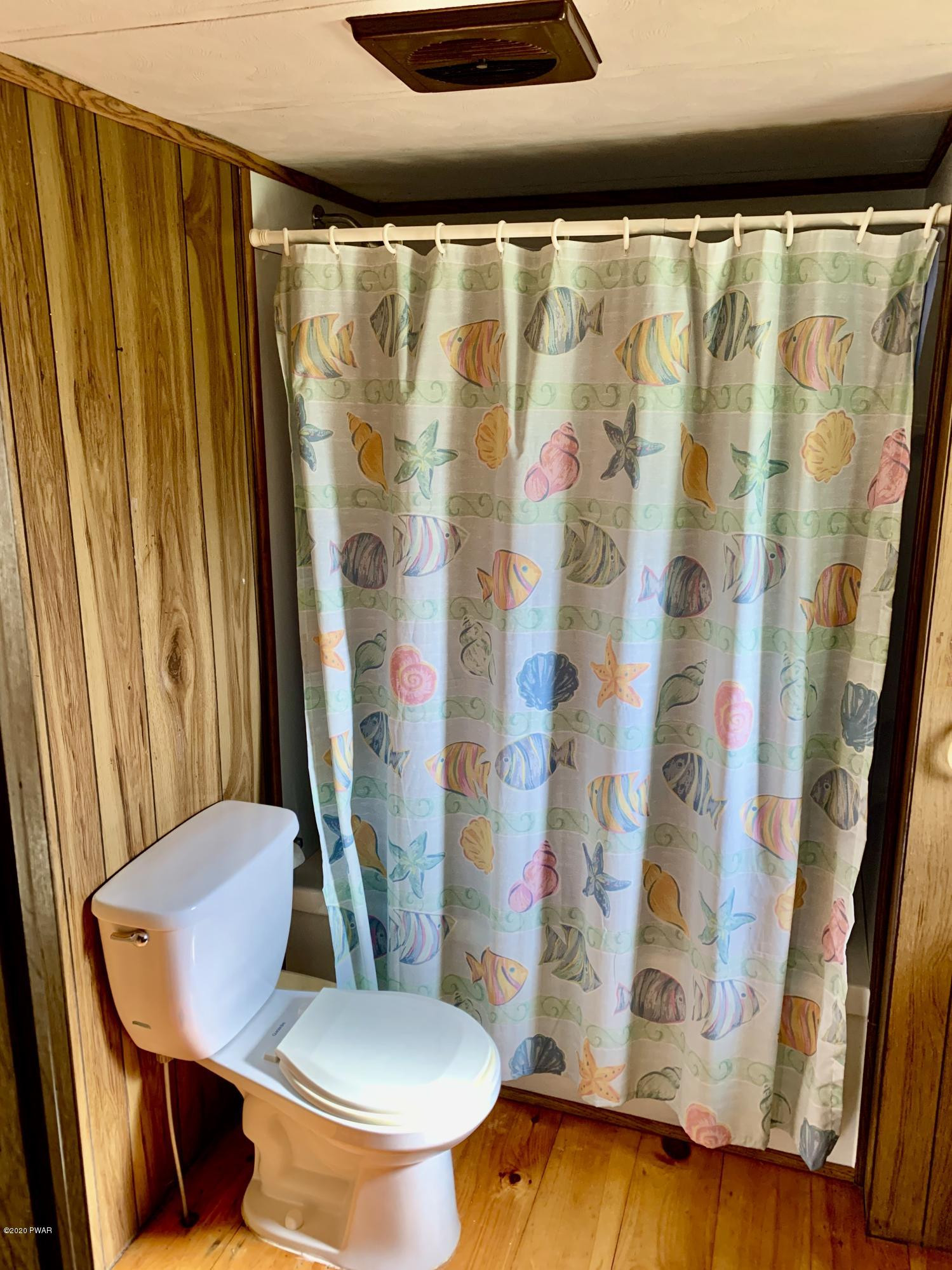 99 Slater Road Beach Lake, PA 18405 - Photo 24 of 35 a bathroom with a toilet and a shower curtain