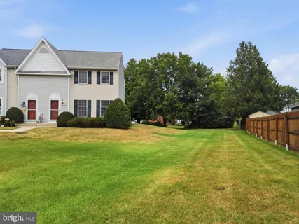 a aerial view of a house with pool and yard
