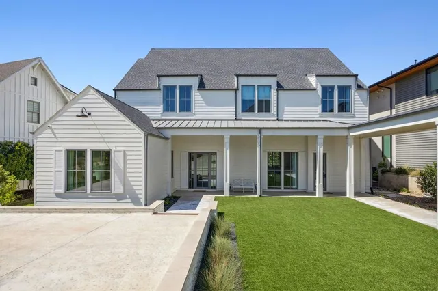 front view of a brick house with a yard