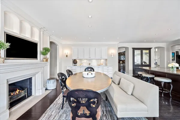 a living room with furniture a dining table and a potted plant