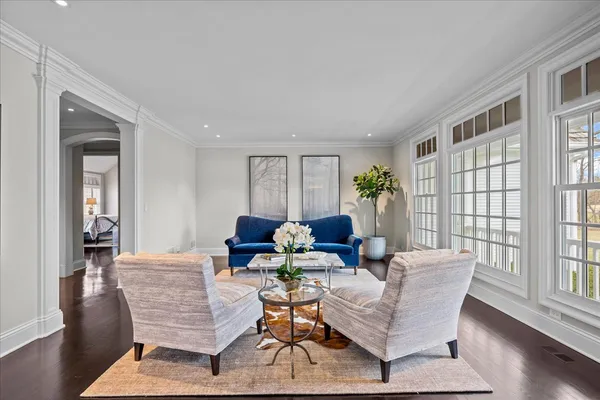 a living room with furniture and wooden floor