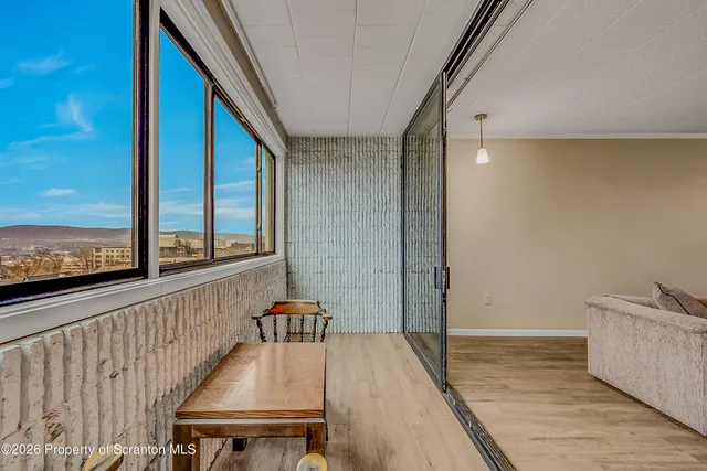 a view of a balcony with furniture and window