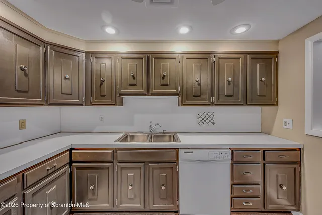 a kitchen with a sink cabinets and appliances