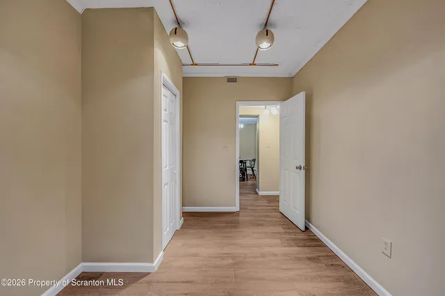 a view of hallway with wooden floor