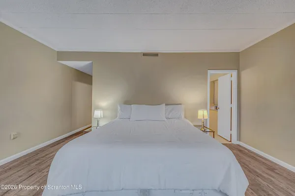 a bedroom with a bed and a night stand