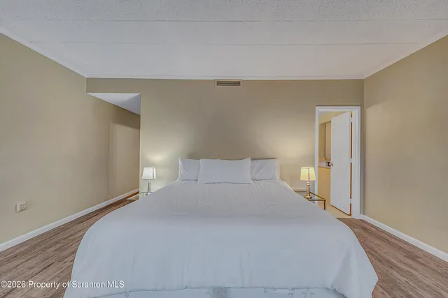 a bedroom with a bed and a night stand