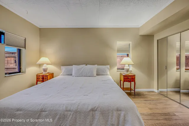 a bed room with a bed and a night stand