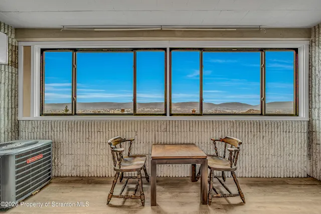 a view of a chair and table in the balcony