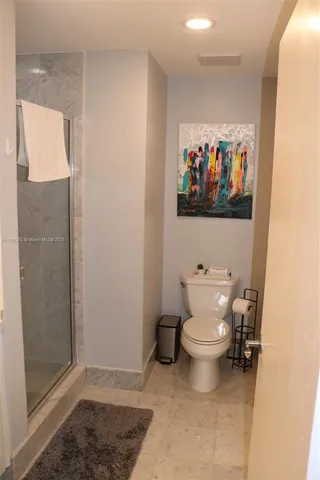 a bathroom with a toilet and shower
