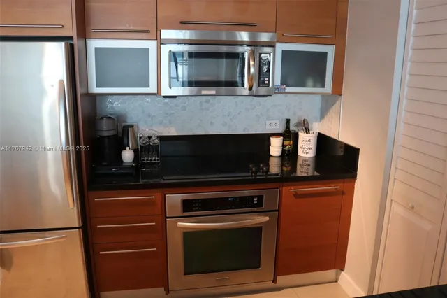 a living room with furniture a rug and kitchen view