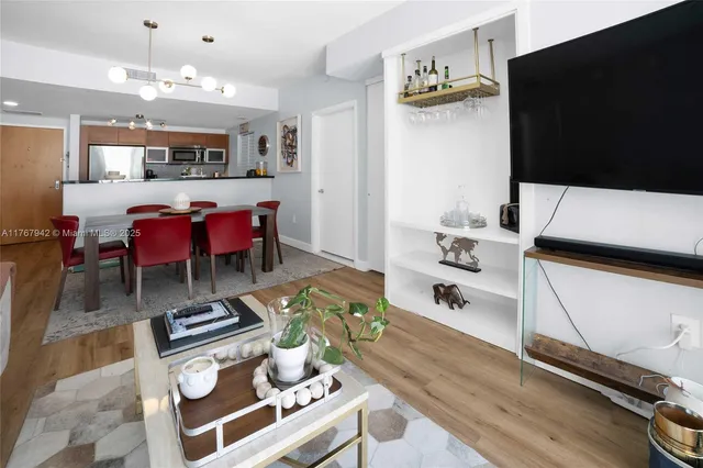 a living room with furniture and wooden floor