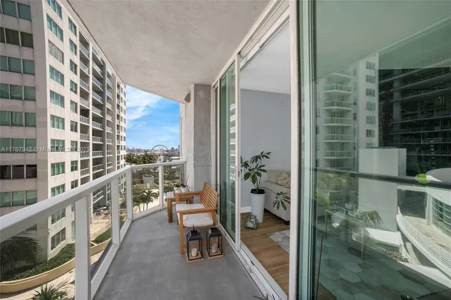 a bedroom with a bed and large windows