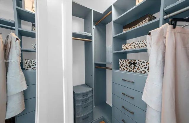 a spacious bathroom with a toilet a sink and a mirror