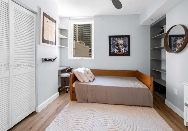 a living room with furniture a flat screen tv and floor to ceiling window