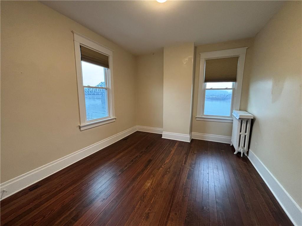 501 Atlantic Avenue Monaca, PA 15061 - Photo 25 of 29 an empty room with wooden floor and windows
