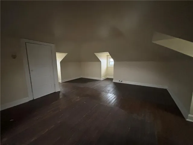 a view of a livingroom with wooden floor and a window