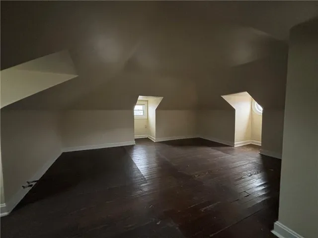 a view of a livingroom with wooden floor and a window
