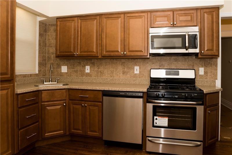 501 Atlantic Avenue Monaca, PA 15061 - Photo 5 of 29 a kitchen with granite countertop a stove and a microwave