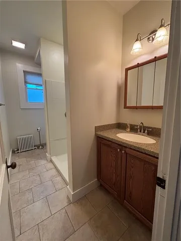 a bathroom with a sink vanity and mirror