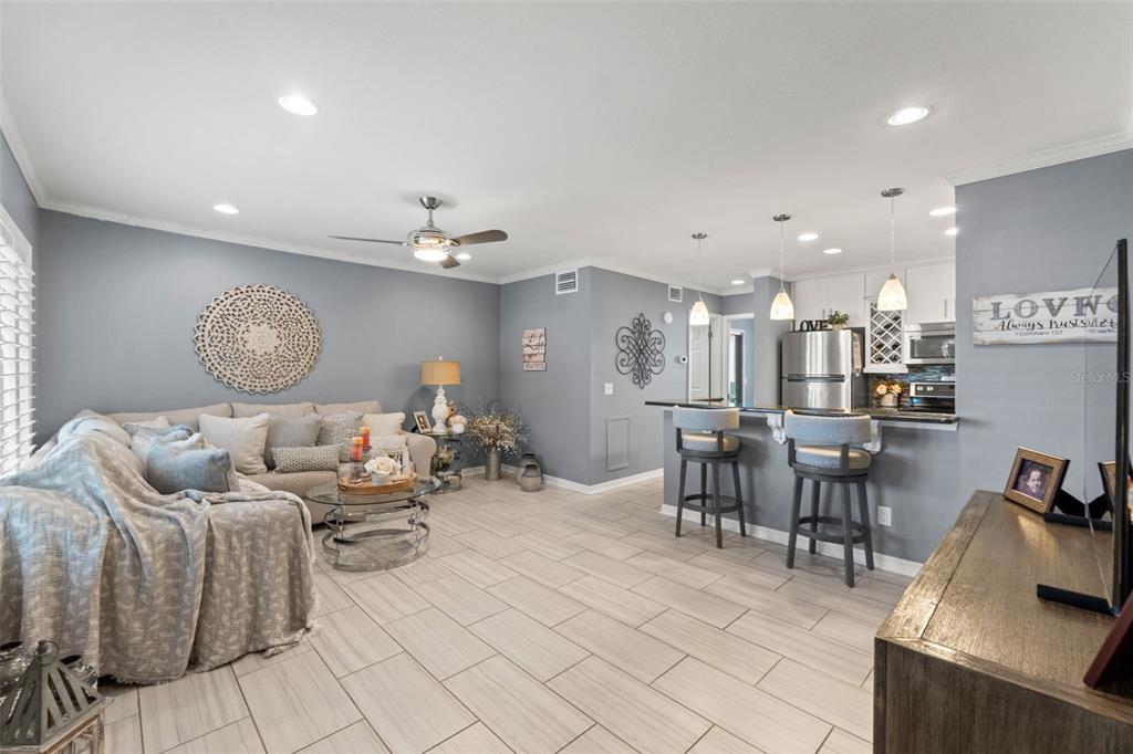 2295 Mexican Way, Unit 41 Clearwater, FL 33763 - Photo 11 of 41 a living room with furniture and a chandelier