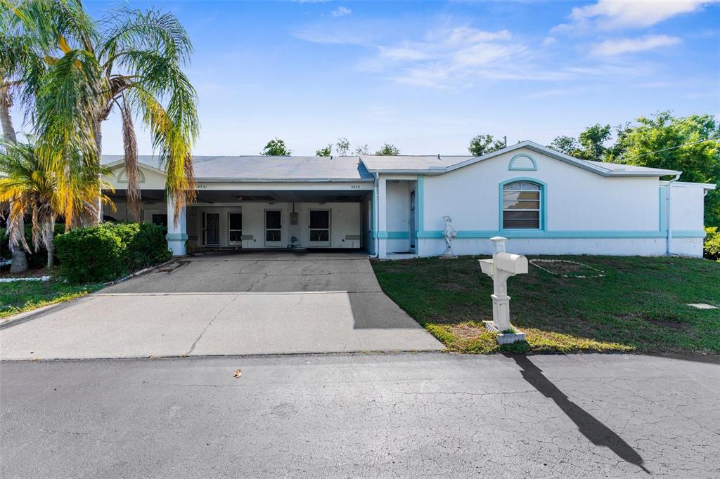 4221 San Rafael Avenue New Port Richey, FL 34655 - Photo 1 of 1 a house with a yard and a trees