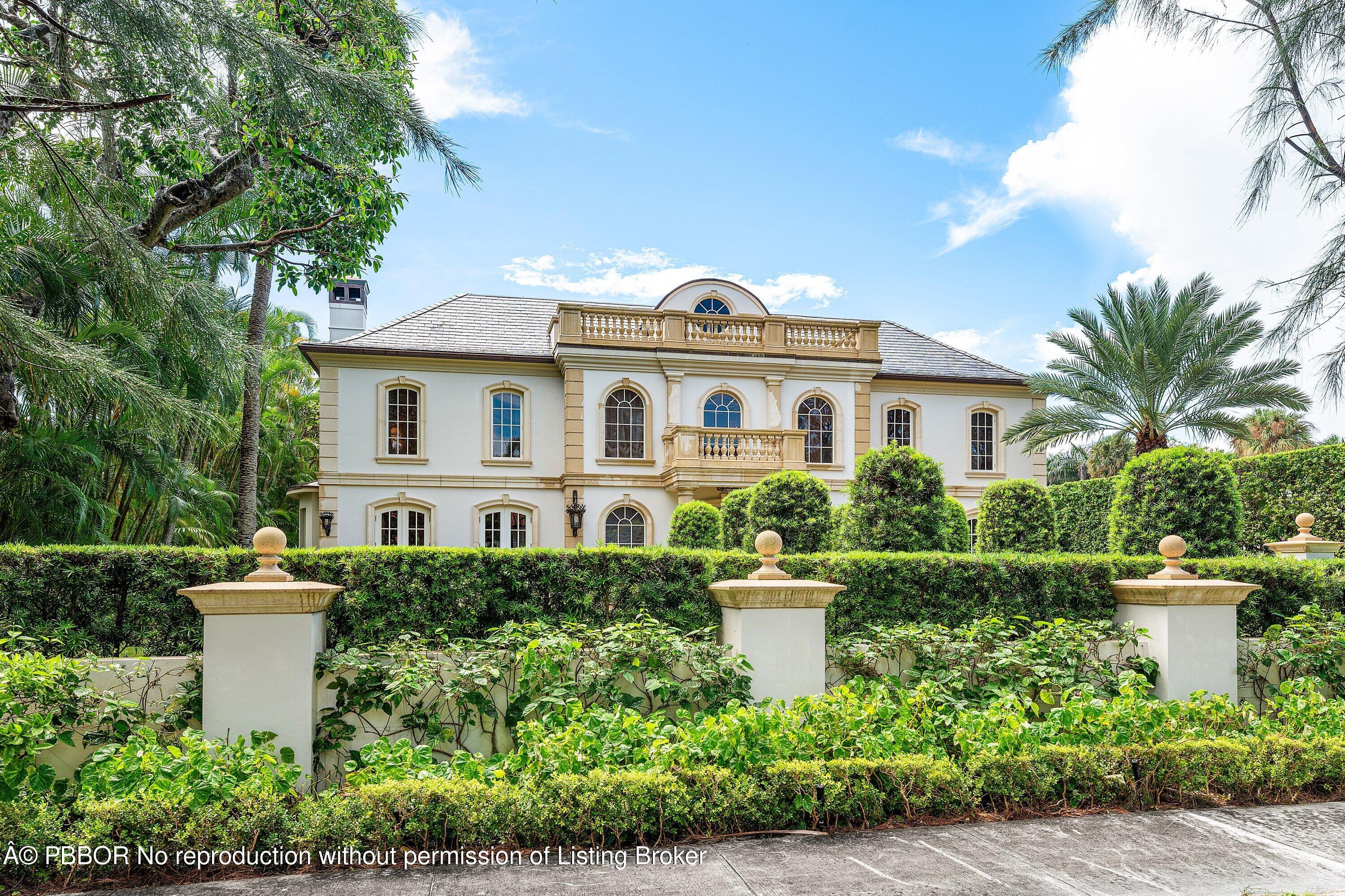 242 Wells Road Palm Beach, FL 33480 - Photo 2 of 54 a view of a white house with a flower garden and a bench