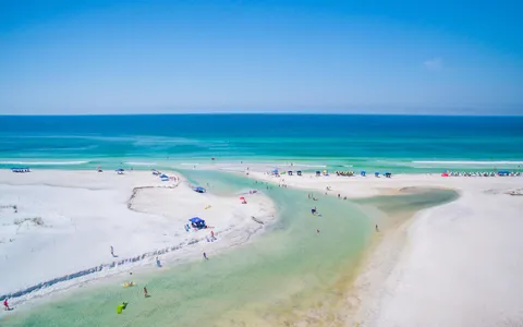 a view of a patio with table and chairs under an umbrella