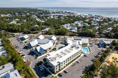 a view of large pool with table and chairs